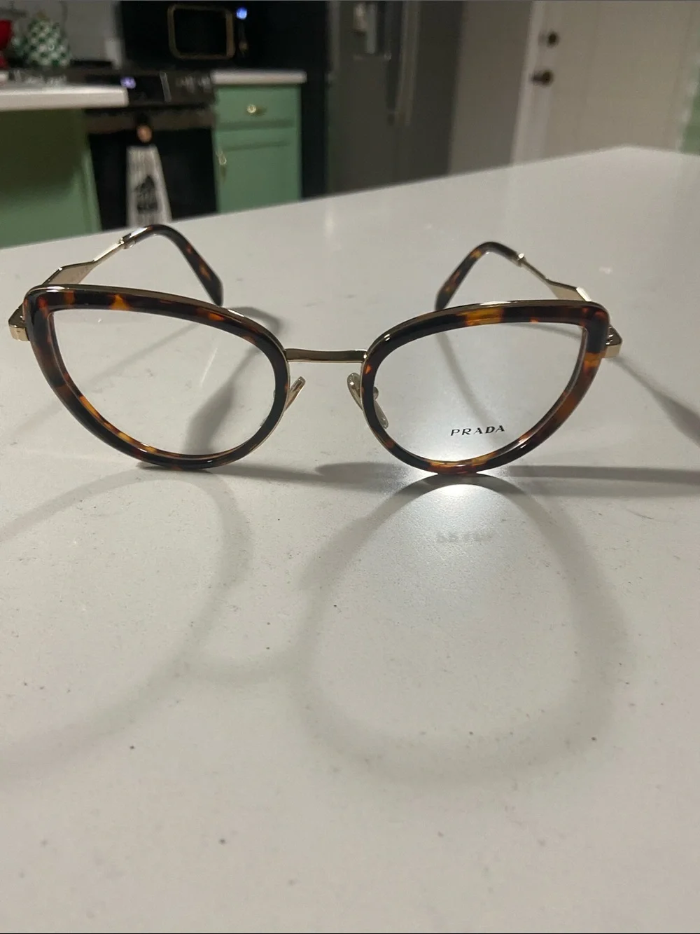 Prada Tortoiseshell Cat-Eye Glasses with Gold Trim